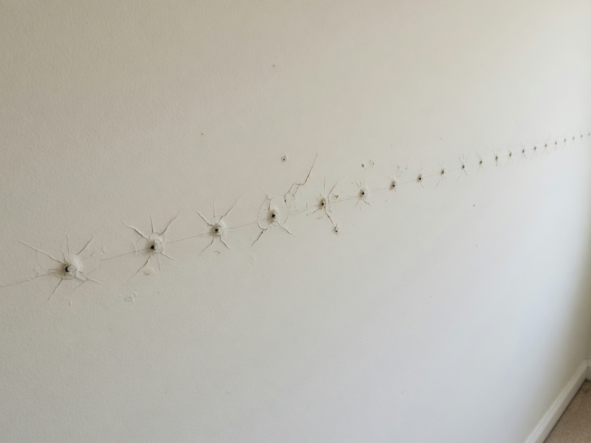 Residential wall with nail pops and small surface defects