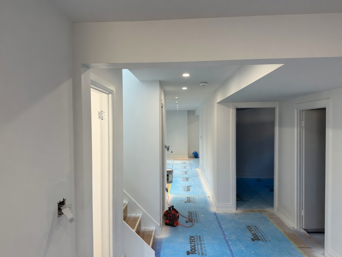 Multi-room residential hallway after drywall finish