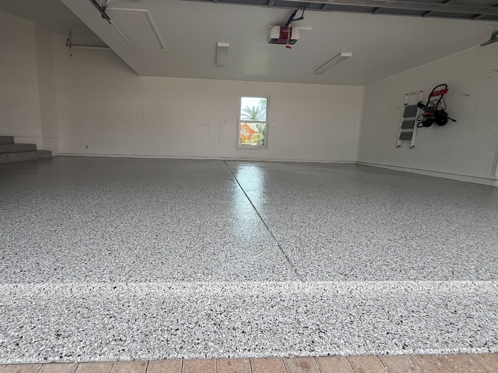 Finished Royal Renovations residential garage floor coating with gray full-flake finish