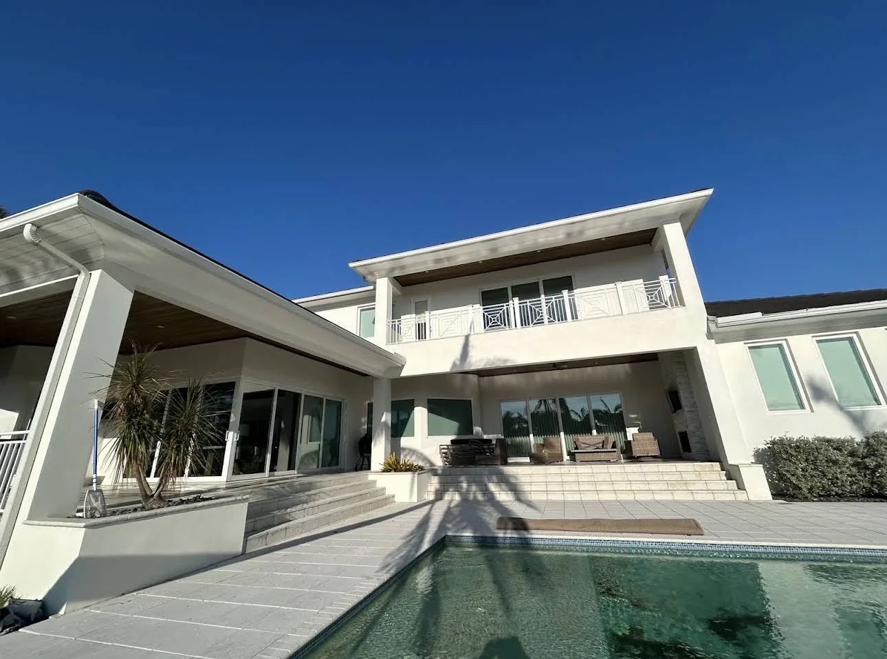 Finished exterior painting beside a pool area