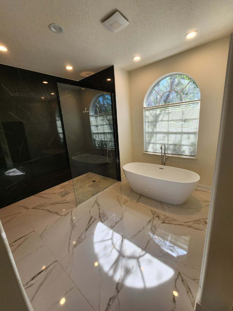 Finished Royal Renovations bathroom remodel with freestanding tub and black tile shower