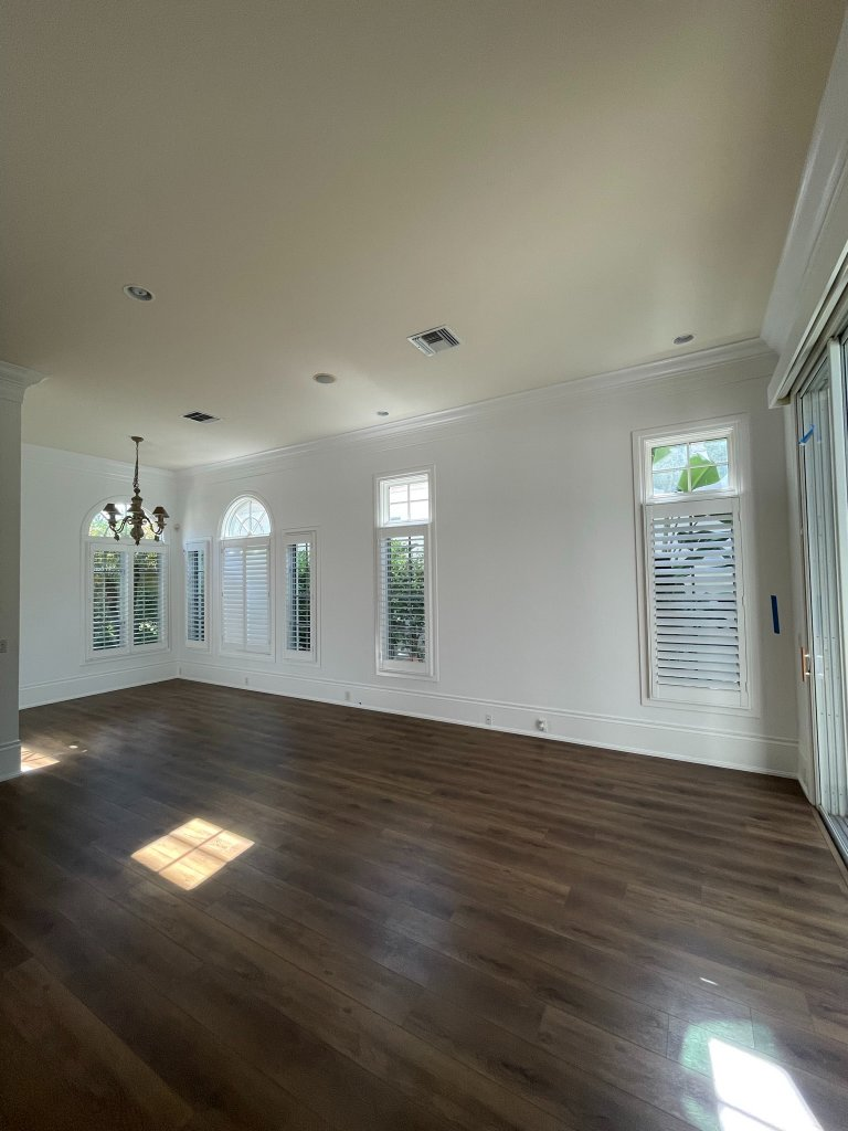 Finished interior room with clean white walls and polished wood floors