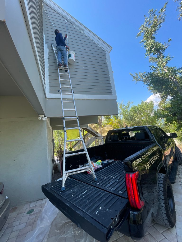 On-site painter working from a ladder
