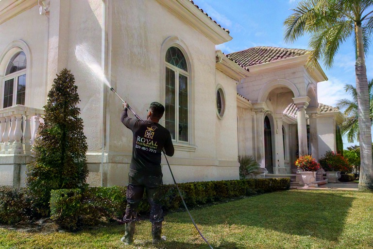 Royal Renovations pressure washing a Southwest Florida home exterior