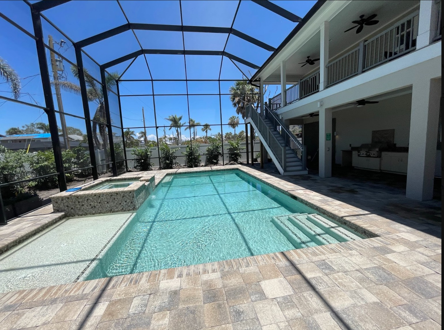 Screened pool, lanai and cage with surrounding pavers